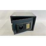 A SMALL STEEL HOME SECURITY SAFE WITH KEYS AND INSTRUCTIONS.