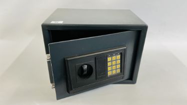 A SMALL STEEL HOME SECURITY SAFE WITH KEYS AND INSTRUCTIONS.