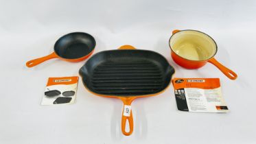 A GROUP OF 3 "LE CREUSET" CAST ORANGE ENAMEL PANS TO INCLUDE A GRILL STYLE EXAMPLE.