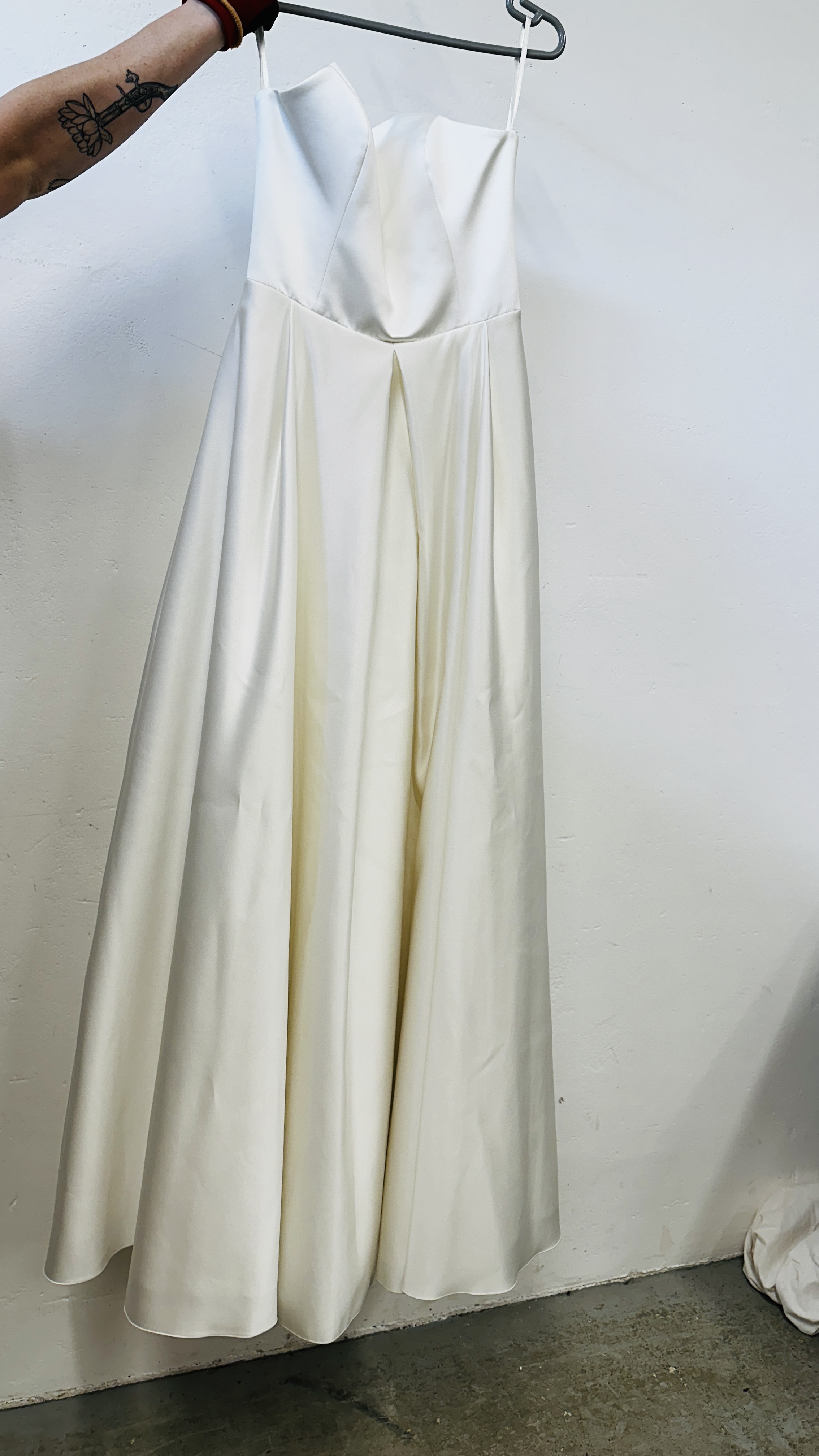 A "BIANCO EVENTO" WEDDING DRESS 40/L ALONG WITH TWO VEILS.