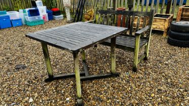 A HARDWOOD GARDEN BENCH LENGTH 120CM AND HARDWOOD GARDEN TABLE - WEATHERED CONDITION, 90 X 90CM.