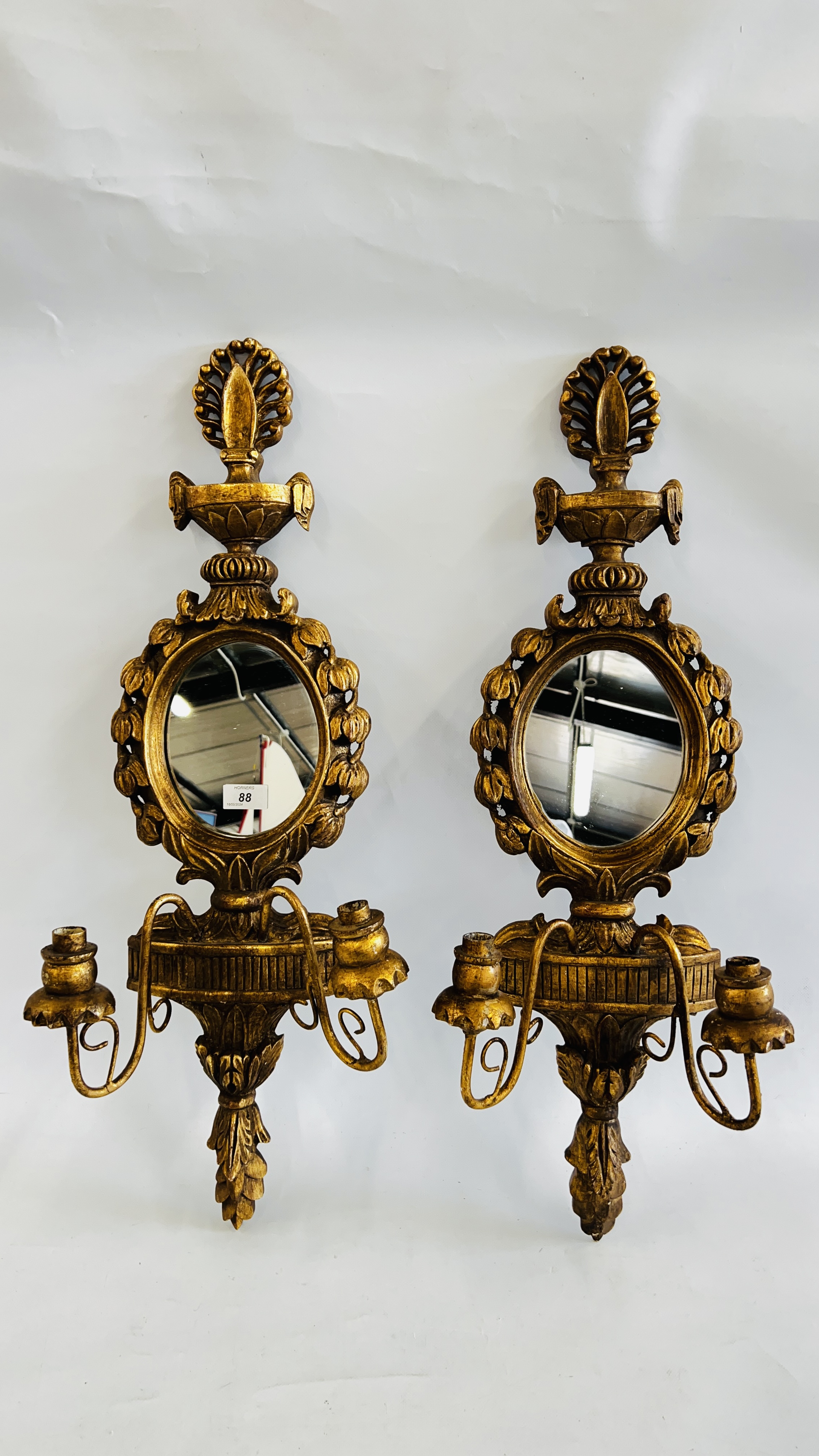 A PAIR OF ELABORATE GILT FINISH TWO BRANCH WALL SCONCES WITH MIRRORED INSERTS H 76CM.
