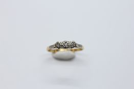 AN 18CT GOLD AND PLATINUM 3 STONE DIAMOND RING.