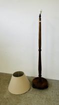 AN OAK STANDARD LAMP AND BEIGE SHADE (CABLE REMOVED) - SOLD AS SEEN.