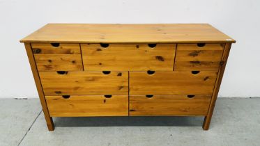 A MODERN HONEY PINE 7 DRAWER SIDEBOARD.