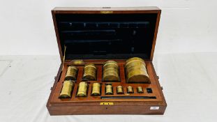 ELEVEN GRADUATED BRASS STANDARD APOTHECARY MEASURES,