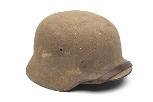 A GERMAN PATTERN M35 STEEL HELMET, of typical form with a 'press-stoff' M31 liner and leather