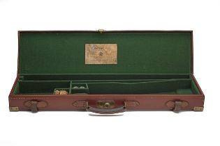 A BRASS-CORNERED LEATHER SINGLE GUNCASE fitted for 30in. barrels, the interior lined with green
