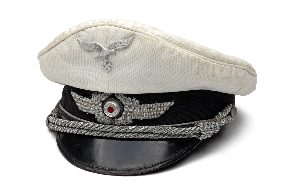 A GERMAN WORLD WAR TWO TUNIC AND PEAKED-CAP FOR AN OBERLEUTNANT IN THE LUFTWAFFE, Airforce blue with - Image 2 of 6