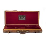 W.J. JEFFERY & CO. LTD. A BRASS-CORNERED OAK AND LEATHER DOUBLE GUNCASE, fitted for 28in. barrels (