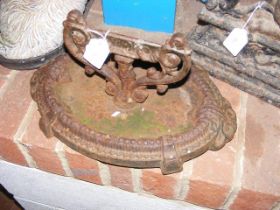 A cast iron boot scraper