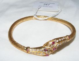 A ladies 21ct snake bangle set with diamonds and r