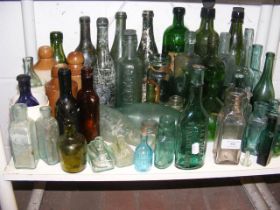 A collection of glass and stoneware bottles, along