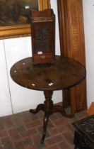 A 19th century oak tripod table with circular top,