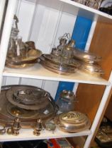 Two shelves of silver plate