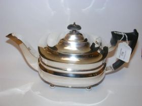 A silver teapot with Sheffield hallmark