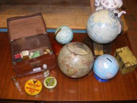 An assortment of vintage globes and product tins i