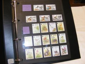 An album of Alderney Mint stamps- set sheets and b