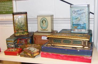 An assortment of vintage product tins, including C