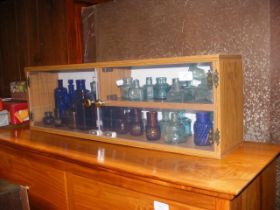 A quantity of old chemist bottles, presented in di