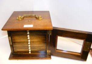 A ten drawer portable coin collectors cabinet, com