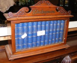 An old glazed bookcase containing the works of Sha