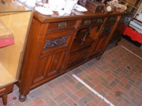 A large mahogany sideboard with three drawers, thr