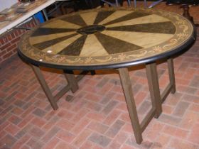 An oval hand painted folding dining table by Graha