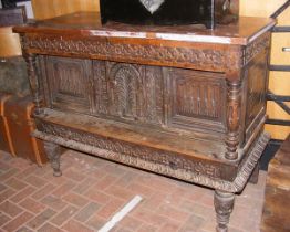 A carved oak cupboard with drawers to the top - 14