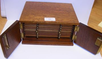 An eight drawer coin collectors cabinet