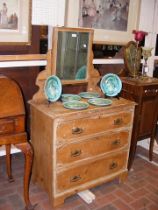 An antique stripped pine dressing table with three