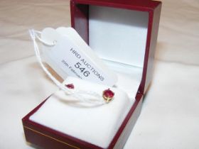 A pair of ruby stud earrings in gold setting