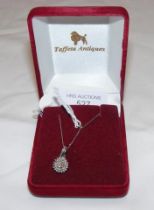 A circular diamond mounted pendant on chain