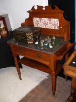 A late Victorian wash stand with marble top tiled