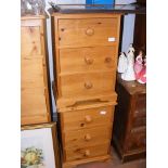 A pair of three drawer pine bedside chests