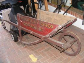 A vintage wooden push-along cart - with signwritin