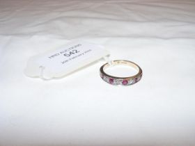 A diamond and ruby half eternity ring