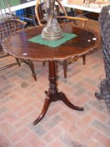 An antique mahogany tripod table on turned support
