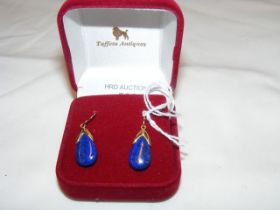 A pair of decorative drop earrings in gold mounts