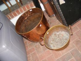 A large copper bucket and two handled brass pot