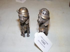 A pair of silver salt and pepper shakers in the fo