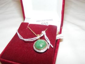 A jade and diamond circular pendant on gold chain