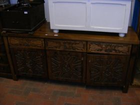 A carved hardwood sideboard with drawers and cupbo