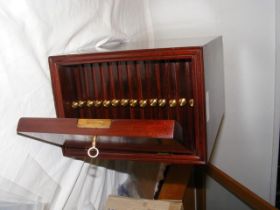 A fourteen tray mahogany lockable, portable coin c