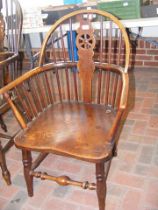 An antique stick back country armchair