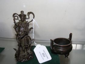 A small bronze deity, together with censor