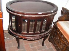 A reproduction oval display cabinet