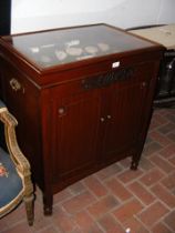 A display case with cupboard below