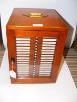 A twenty drawer mahogany coin collector's cabinet