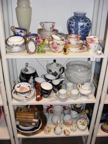 Three shelves of collectable ceramic ware, includi